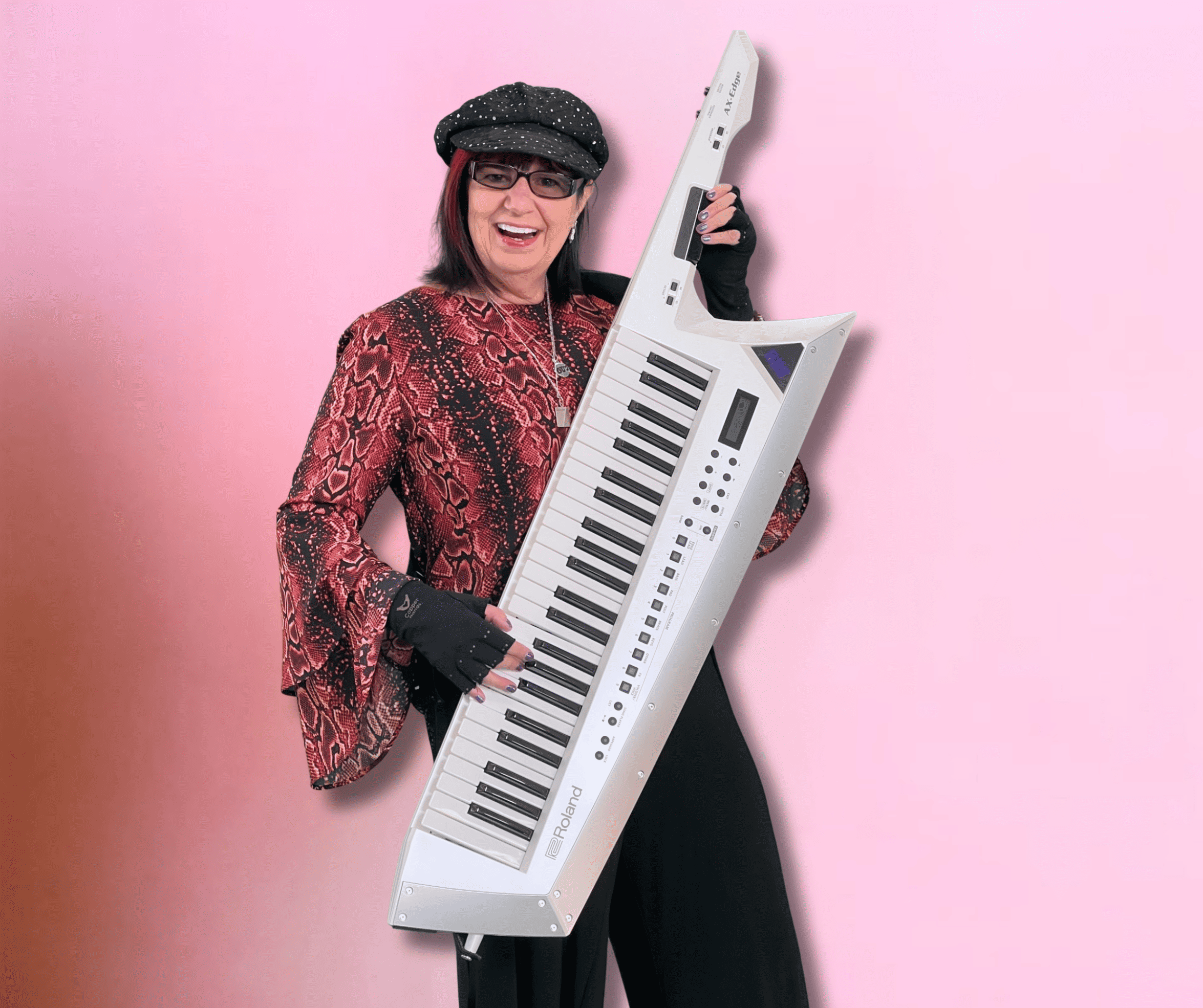 Gail Taylor holding a keytar and smiling, dressed in a patterned shirt, black trousers, and a cap, against a pink background, embodies the midlife pivot from finance to music inspiration.