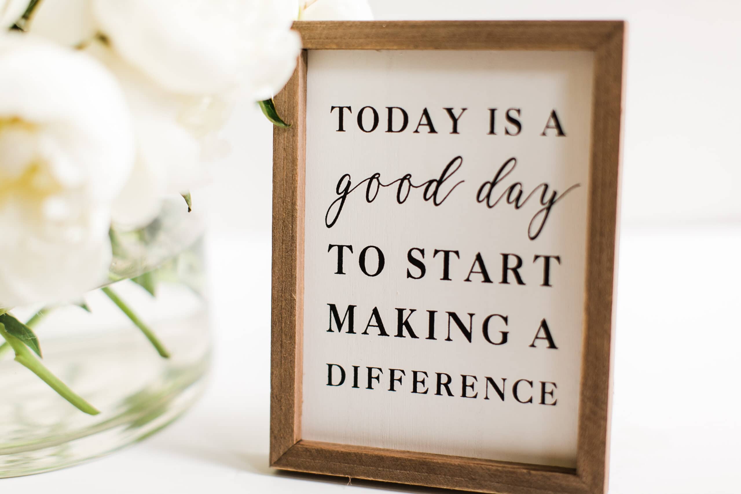 Inspirational quote in a wooden frame: "Today is a good day to start making a difference – embrace a new perspective on menopause.