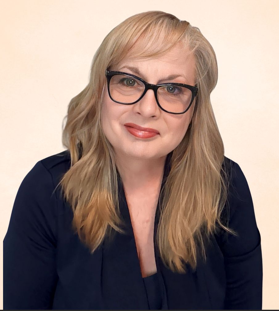 Upcoming Guest's Janet Zavala with shoulder-length blonde hair and glasses, wearing a black top, posing against a light beige background. Janet Zavala's poised expression adds an air of elegance to the scene.