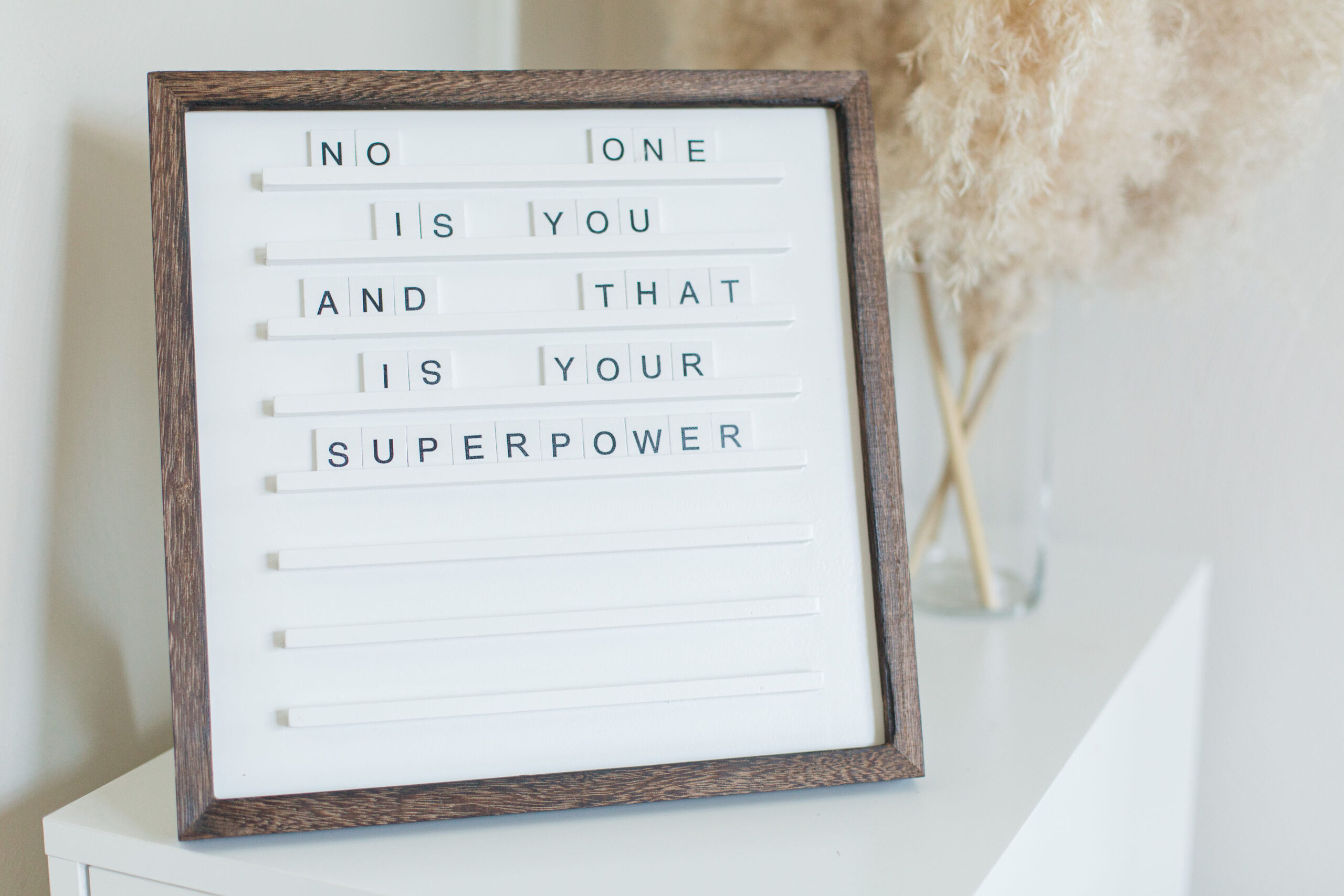 A framed letter board on a white shelf displays the uplifting message: "No one is you and that is your superpower," offering a gentle reminder of inner strength, much like finding relief during challenging times.